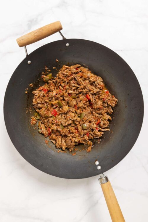 Savory shredded beef with peppers in a skillet, ready for Mexican or comfort food recipes.