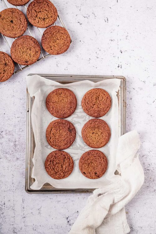 Fudgy homemade chocolate chip cookies on a parchment-lined baking sheet. Perfect for dessert or snack.