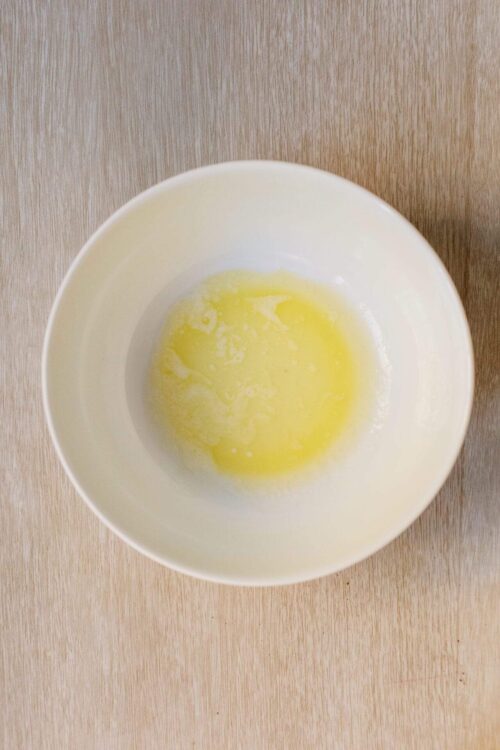 Beaten eggs in a white bowl for baking or cooking, close-up.