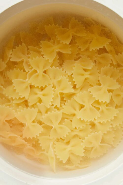 Farfalle pasta in boiling water for homemade pasta recipes.