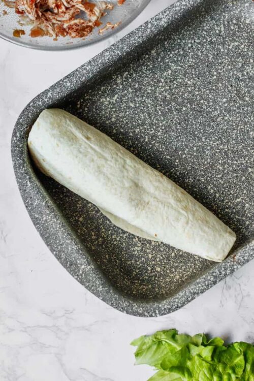 Freshly prepared pizza dough in a baking pan for homemade pizza crust.
