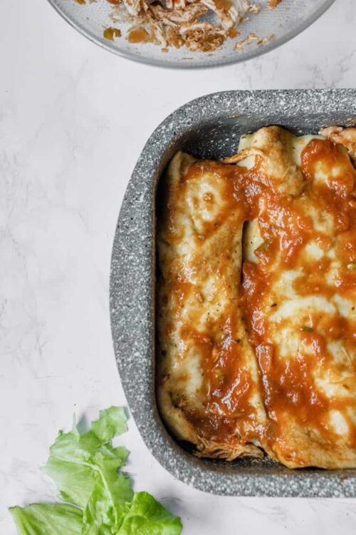 Cheesy baked eggplant parmesan in a stone baking dish, topped with marinara sauce and melted mozzarella, served fresh from the oven.