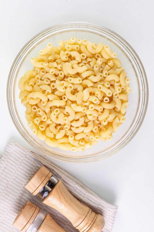 Uncooked pasta in a clear glass bowl, ready to cook.
