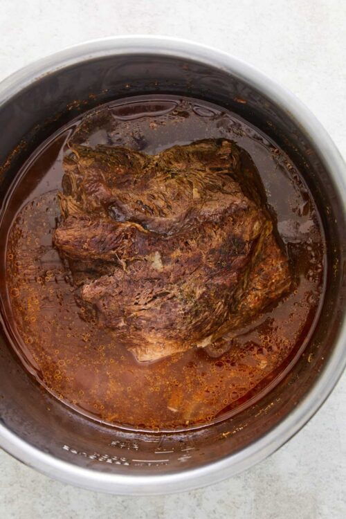 Slow cooker chuck roast in rich beef gravy, perfect for hearty comfort food.