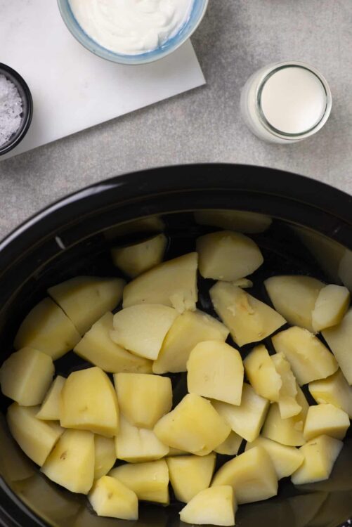 Golden peeled potatoes in a slow cooker for delicious mashed potatoes or potato dishes.