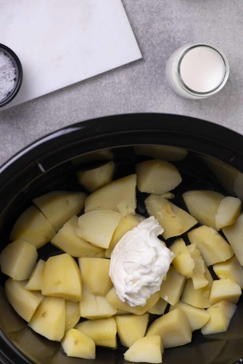 Boiled potatoes with cream in a slow cooker, ingredients for comfort food recipe.