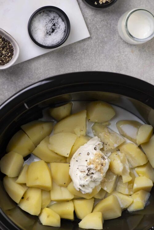 Creamy potato and sour cream mixture in a slow cooker for comfort food recipes.