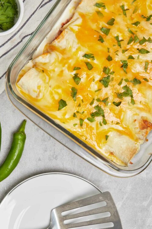 Creamy cheesy chicken enchiladas baked casserole.