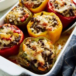 Stuffed bell peppers filled with rice, black beans, cheese, and vegetables, baked to perfection. Perfect for a healthy, delicious meal.