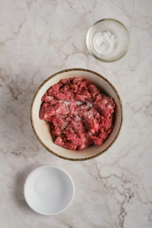 Minced beef and salt in a bowl for baking recipes.
