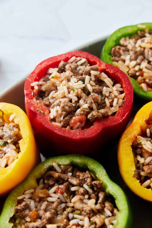 Colorful stuffed bell peppers filled with rice and seasoned ground meat.