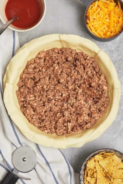 Ground beef mixture in pie crust for savory casserole or meat pie.