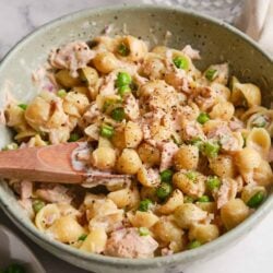 Creamy chicken salad with chickpeas, celery, and herbs in a ceramic bowl.