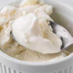 Creamy homemade vanilla ice cream in a white ramekin. Perfect for summer desserts and cold treats.