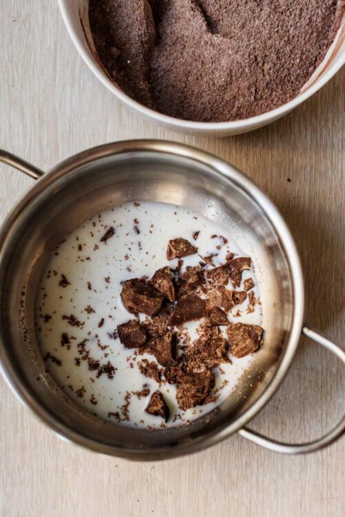 Melting chocolate and cream in a saucepan for baking recipes.