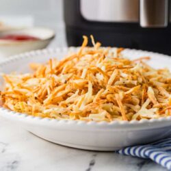 Shredded chicken casserole in a white baking dish for cozy family dinner.