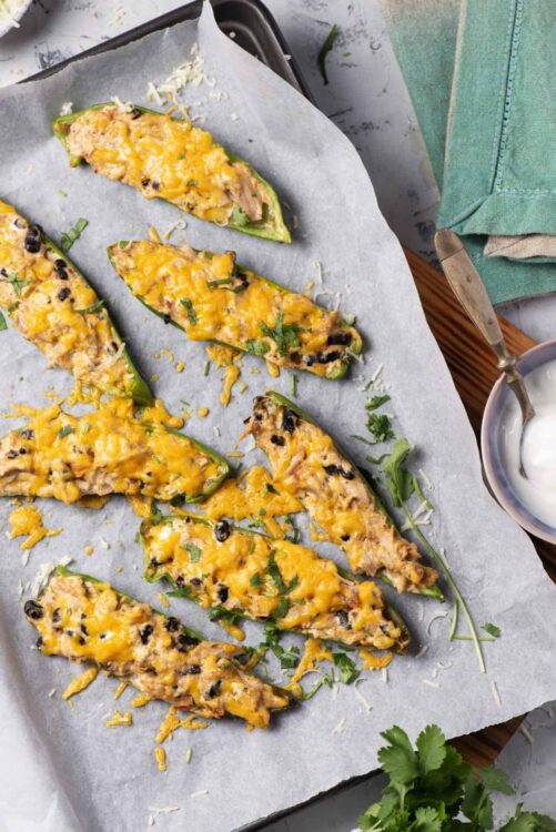 Baked stuffed jalapeño peppers with melted cheese and black beans.