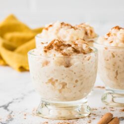 Creamy cinnamon spiced whipped dessert in glass bowls, perfect for holiday gatherings.