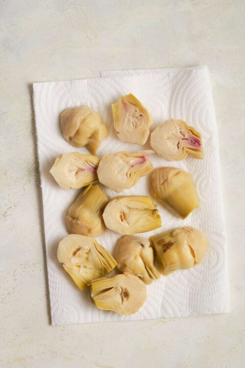 Fresh cooked artichoke hearts on paper towels during preparation for healthy recipe.