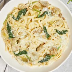 Creamy chicken Alfredo pasta with spinach and Parmesan cheese.