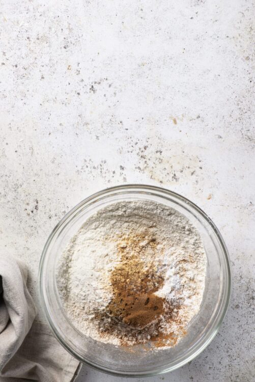 Flour and spices in a glass mixing bowl for baking recipes.