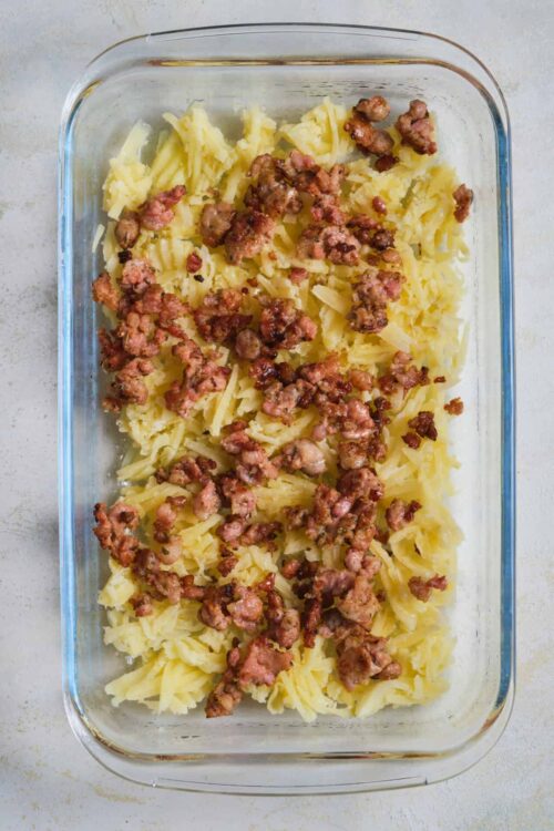 Savory meat and mashed potatoes casserole in glass dish.