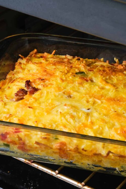 Cheesy baked casserole with bacon in a glass dish, homemade comfort food recipe.