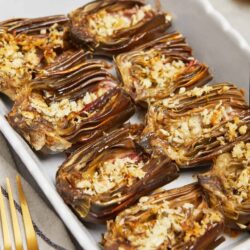Baked stuffed eggplant with breadcrumbs and cheese, baked to golden perfection.
