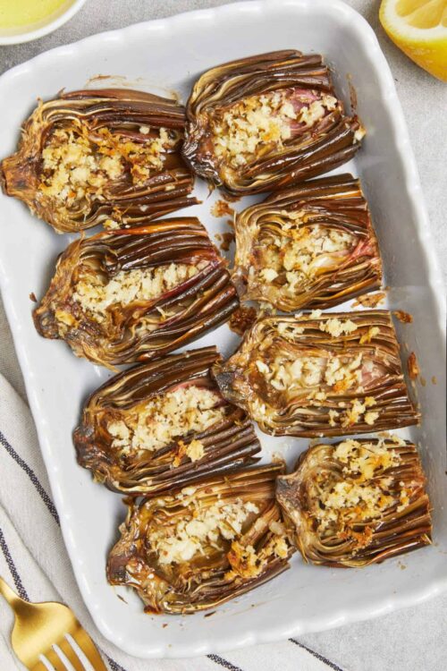 Baked Eggplant Parmesan with melted cheese and crispy breadcrumb topping on a white baking dish.