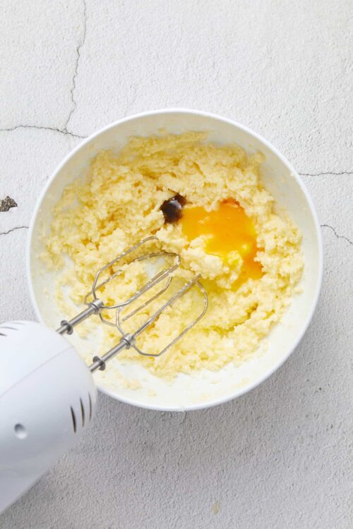 Creamy butter and sugar mixture for baking with an electric hand mixer.