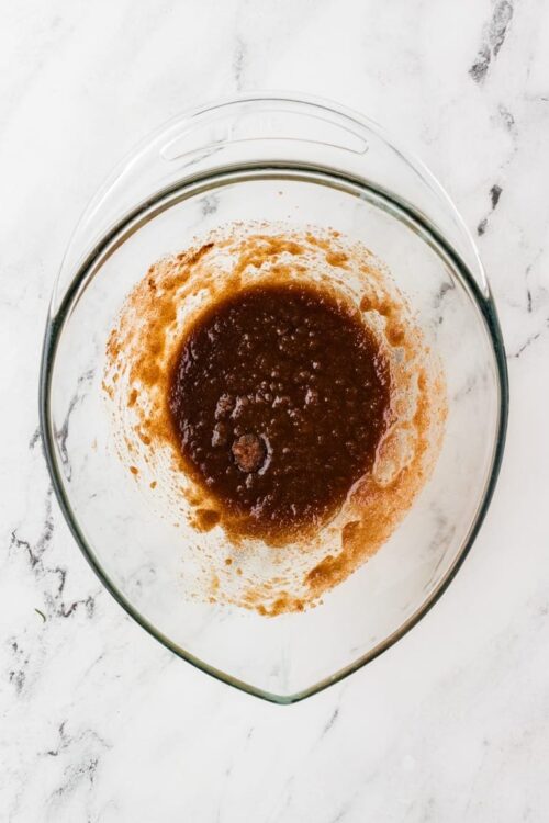 Dark caramel sauce in glass mixing bowl, baking ingredients for dessert, Baked Bree recipe, caramel preparation, baking step photo.