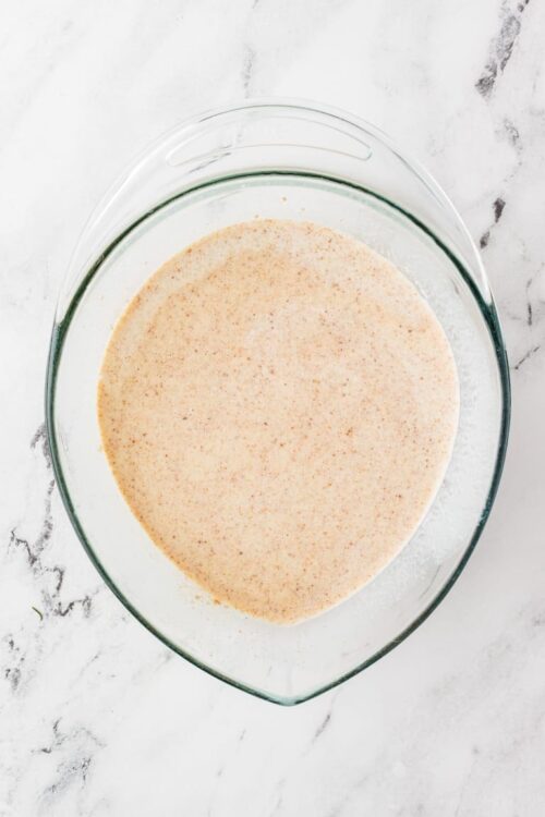 Creamy cinnamon-infused batter in a glass mixing bowl ready for baking.
