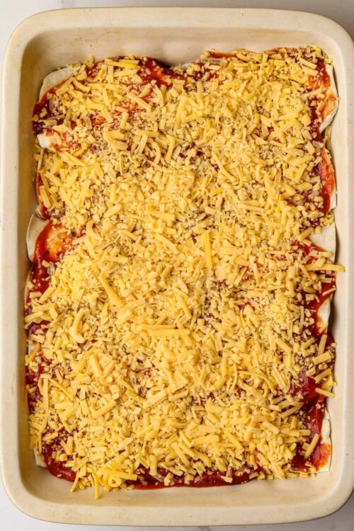 Cheese lasagna baking dish with melted mozzarella cheese and tomato sauce.
