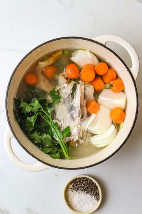 Fresh homemade chicken vegetable soup with carrots, onions, and herbs in a creamy broth.