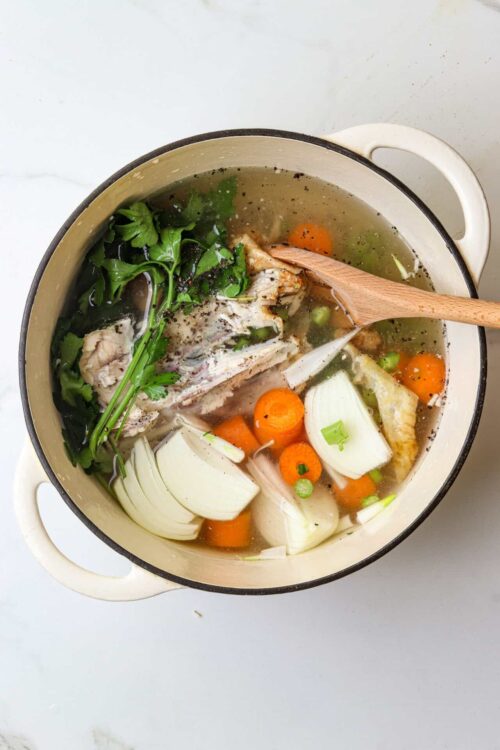Savory homemade chicken soup with vegetables in a pot for comforting meal.