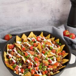 Crunchy beef taco skillet with fresh tomatoes and green onions. Perfect for easy weeknight dinners.