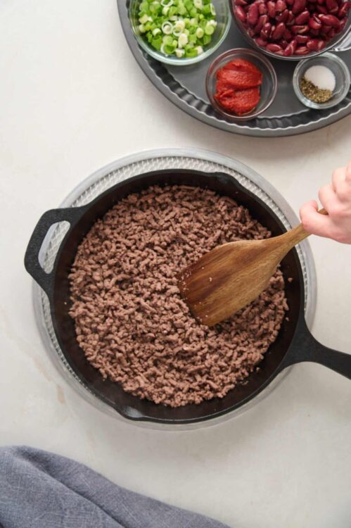 Ground beef cooking in a skillet for lasagna or taco recipe.