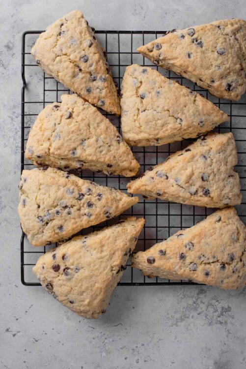 Buttery blueberry scones on wire rack fresh from the oven, perfect for breakfast or tea time.