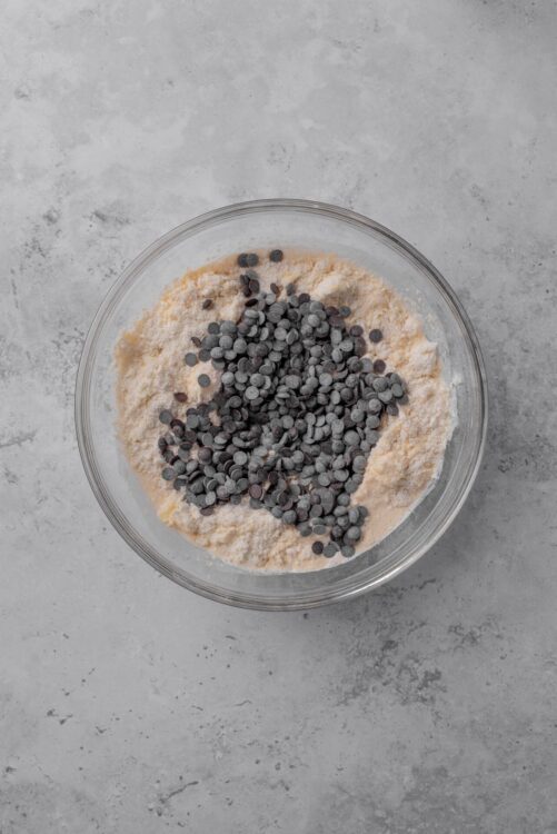 Mini chocolate chips in a bowl of cookie dough for baking desserts.