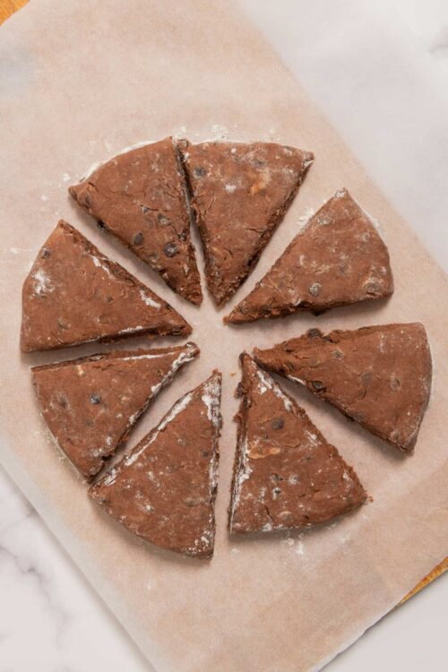 Rich chocolate chip cookie dough slices on parchment paper.