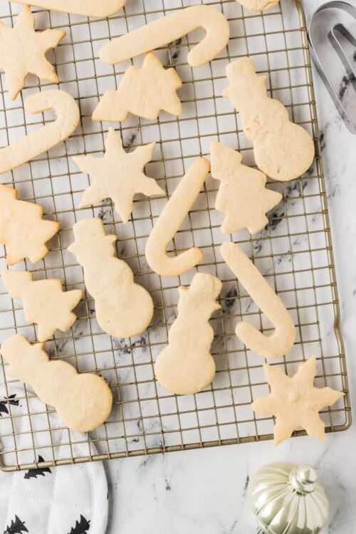 Cookies cut into Christmas shapes, ready for baking.
