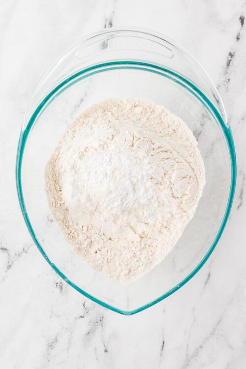 Flour mixture in a glass bowl for baking recipes.