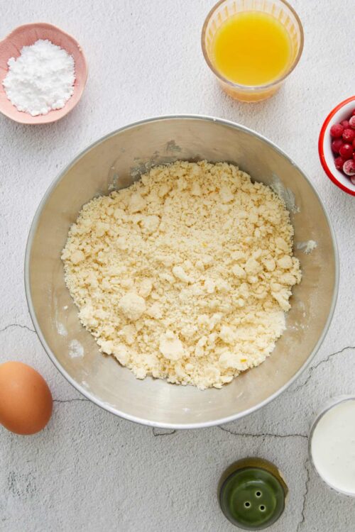Crumbly pie dough in a mixing bowl.