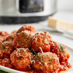 Savory Italian meatballs in rich tomato sauce garnished with herbs and cheese. Perfect for weeknight dinners or special occasions.