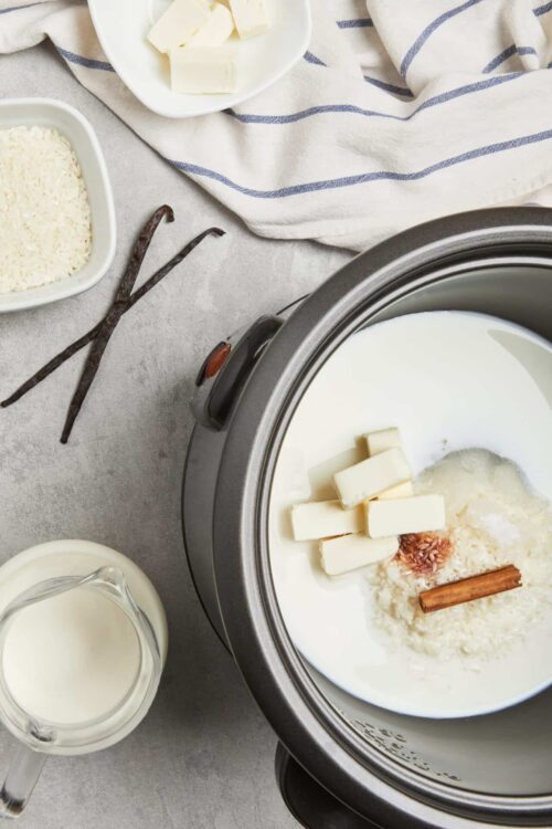 Cream cheese and milk in a slow cooker for making homemade cheese sauce or creamy recipes.