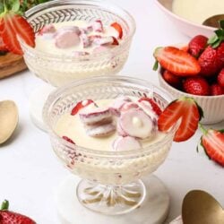 Fresh strawberry dessert with sliced strawberries and creamy yogurt in elegant glass bowls, perfect for summer treats.