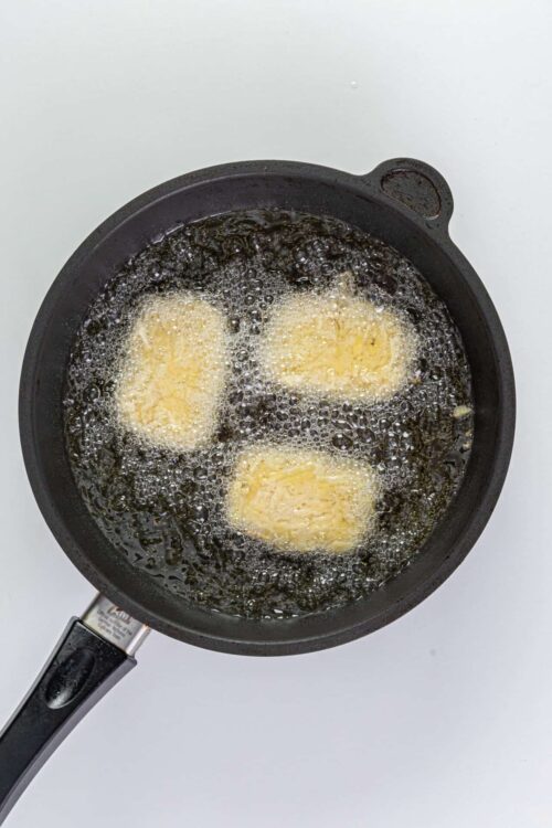 Golden brown butter being fried in a cast iron skillet.