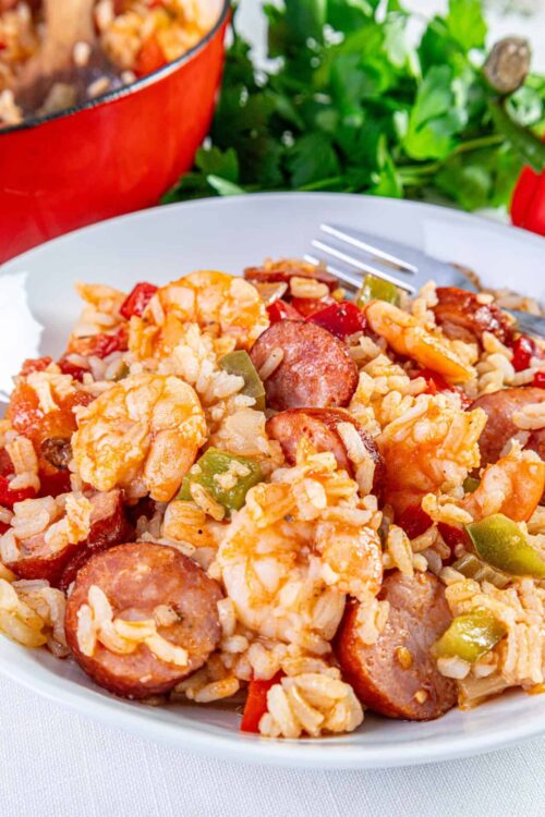 Savory sausage shrimp and rice skillet in white bowl, baked bree recipe, comforting easy dinner idea, high-quality food photography.