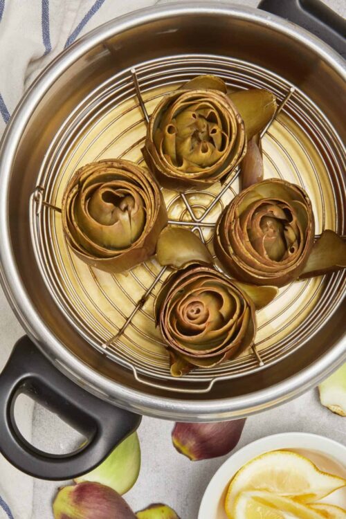 Roasted artichokes in a steam basket ready to serve.