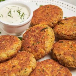 Crispy homemade crab cakes with a side of herbed sour cream sauce. Perfect appetizer or main dish for seafood lovers.